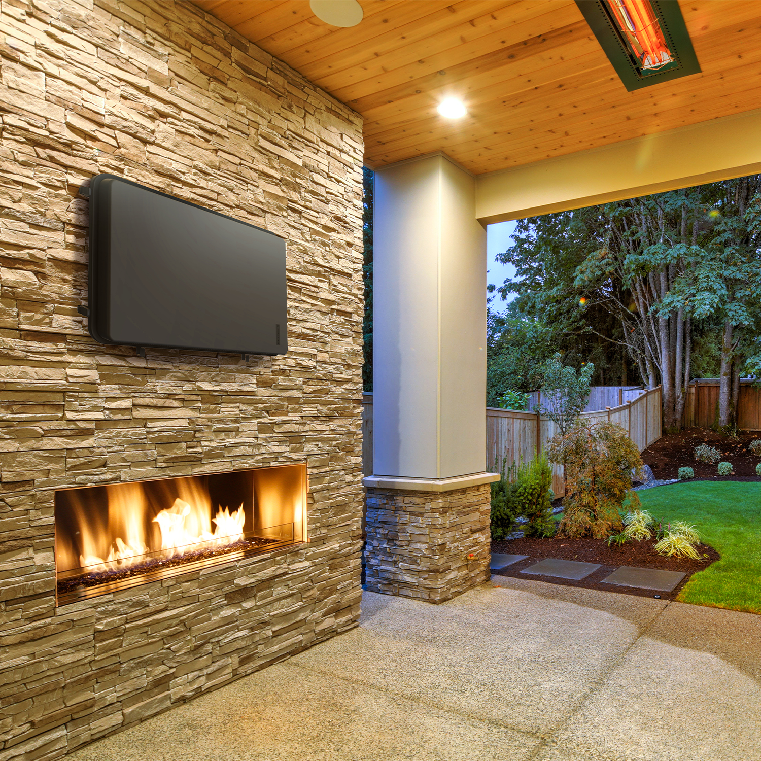 Storm Shell Outdoor Weatherproof TV Enclosure  with ariticulating arm and mounting hardware. Fits up to 44" TV  lifestyle image. Mounted on a rough rock brick wall over a fireplace